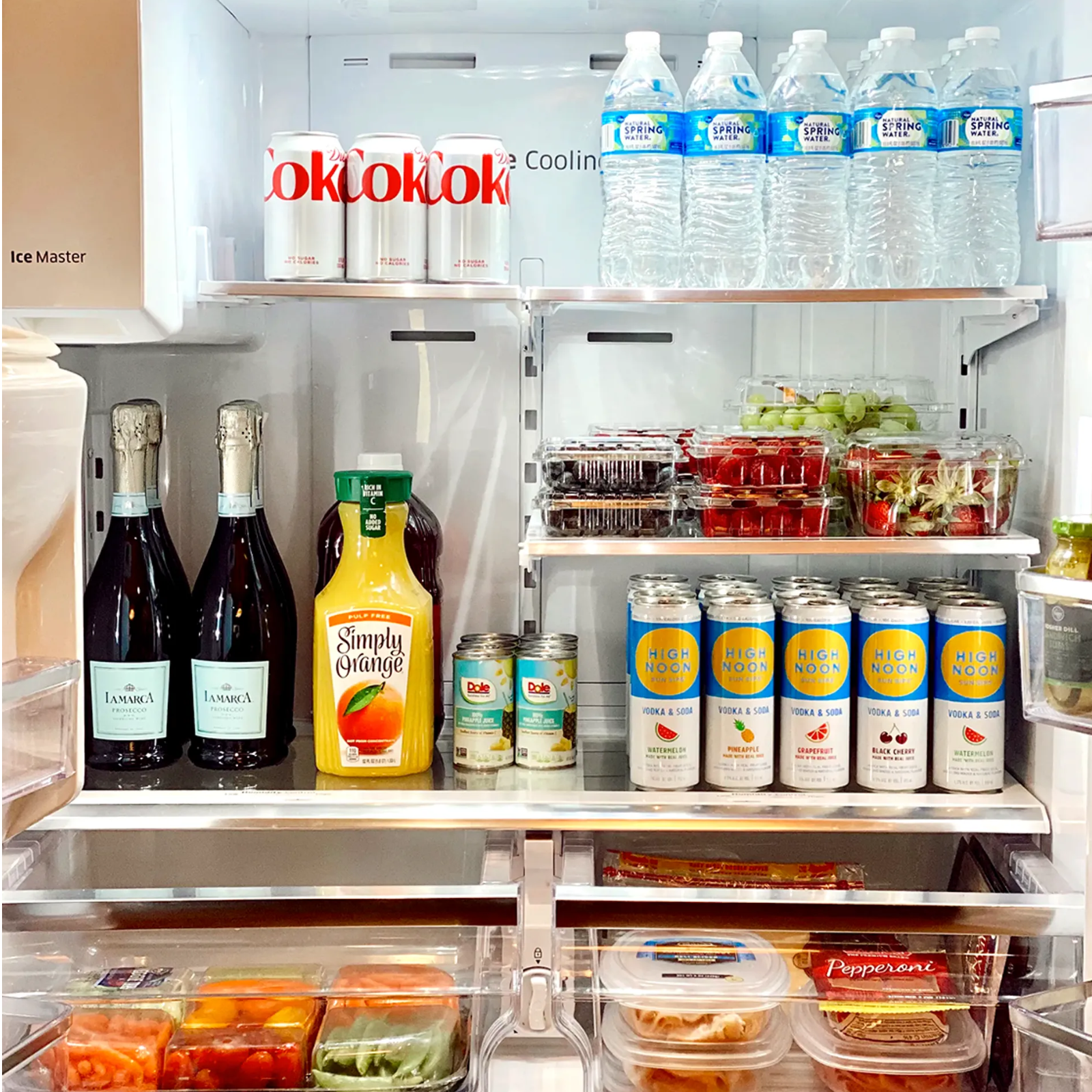 Belles&Bach (1) A refrigerator with many drinks and food on it.